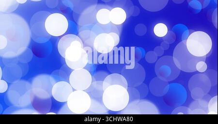 Floating white and blue blurred circular light spots forming pattern in abstract digital background Stock Photo