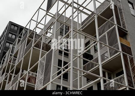 Balcony grid and white frame structure on a residential block at Sloterdijk, Amsterdam, Netherlands, viewed from street level on an overcast day. Stock Photo