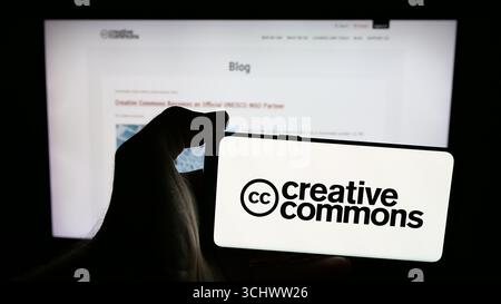 In this photo illustration, a mobile phone with the logo of US organisation Creative Commons (CC) is seen on screen in front of web page. Stock Photo