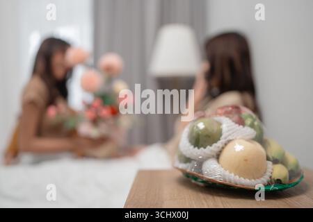 A Cozy Indoor Scene with Flowers and Decorative Fruits on a Wooden Table Stock Photo