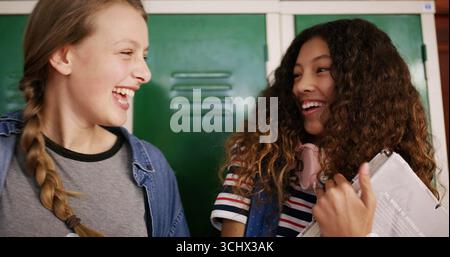 Laughing, students and talking with friends in high school for education, project assignment or study team. Joke, learning and exam planning with Stock Photo