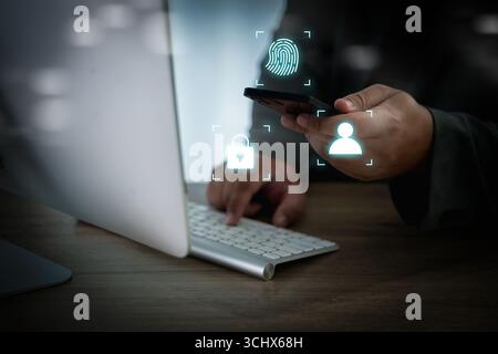 Cybersecurity and mobile authentication concept, businessman using smartphone with face ID, fingerprint, and data protection icons in modern office wo Stock Photo