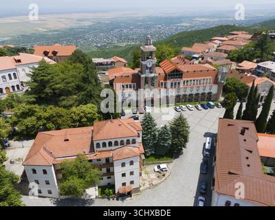 Square with a dominant tower and traditional buildings surrounded by green hills, aerial view, Sighnaghi, Signagi, Kakheti Province, Greater Caucasus Stock Photo