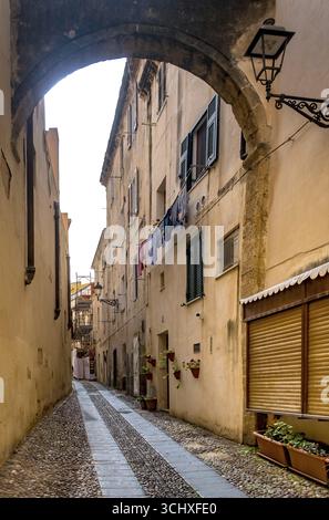 Sardinia, Narrow cobblestone alley and houses in the old town, Laundry by the window, Alghero, Europe, Province of Sassari, Italy, old building, old t Stock Photo