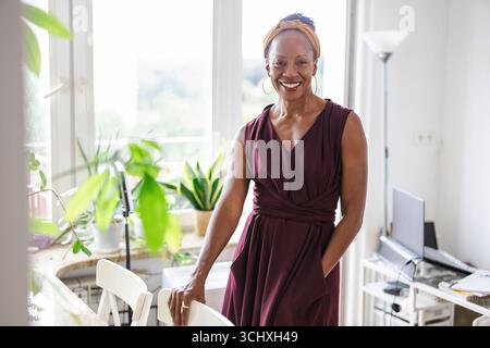 Portrait of a smiling businesswoman standing in the office Stock Photo