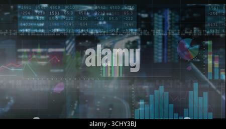 Displaying interactive dashboard grid over nighttime roadway, with numeric tables and charts Stock Photo