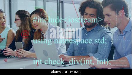 Collaborating five professionals reviewing code on laptops and smartphone at office meeting table Stock Photo