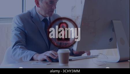 Typing businessman in suit working on desktop computer in office, with padlock icon and coffee cup Stock Photo