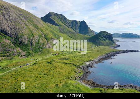 coastal road between mountain range and rocky coast, aerial view, Norway, Vesteralen, Langoya, Hovden Stock Photo