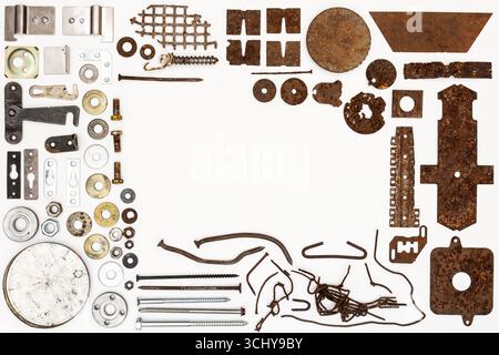 A group of various old and new bits and pieces arranged on white. Old rusty nuts, bolts, nails and other parts flay lay on white background. Stock Photo