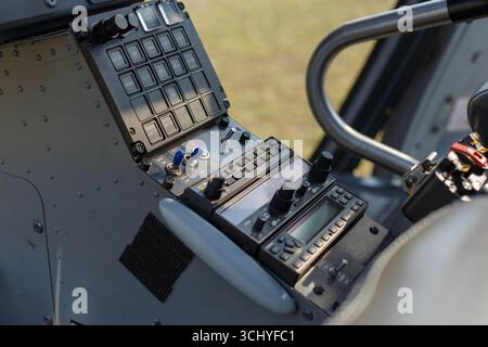 Close-up view of helicopter cockpit controls showing essential instruments and buttons during flight preparation. Stock Photo