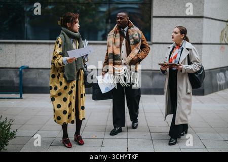 Group of Diverse Professionals Collaborating Outdoors During a Scenic Morning Stock Photo