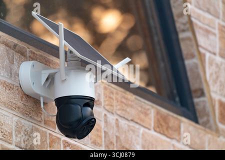Solar powered wireless security camera on country house wall Stock Photo