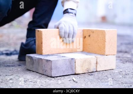 Building a fire pit structure from fireproof bricks. Stock Photo