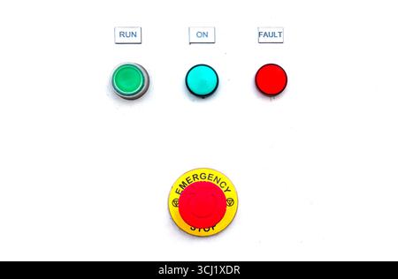 Instrument panel with buttons to start and stop systems in the ship's engine room and an emergency stop button. Stock Photo