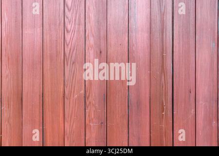 Close-up of a red-brown, vertically-slatted wooden fence, London, UK Stock Photo