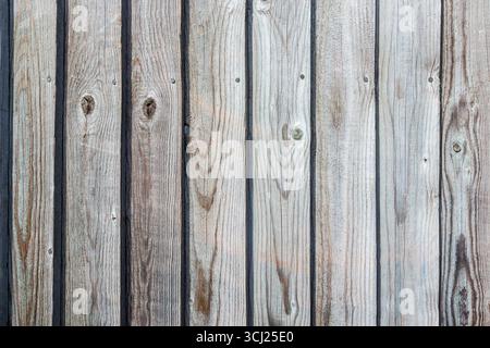 Close-up of a brown, vertically-slatted wooden fence, London, UK Stock Photo