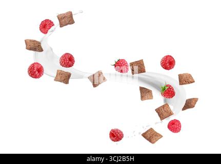 Splashing milk with sweet corn pads and fresh raspberries in air against white background. Healthy breakfast Stock Photo