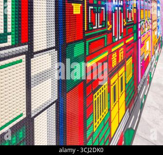 Colorful LEGO wall art depicting a vibrant, abstract cityscape with intricate brick details and bold, contrasting colors Stock Photo
