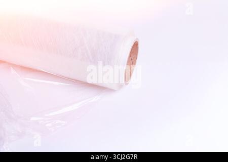Packaging material. Stretch film and cardboard packaging on a white background. Packing the goods before shipping.. Stock Photo