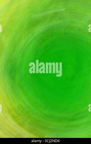 Abstract green light trail vortex. Lights moving in circular green pattern. Stock Photo
