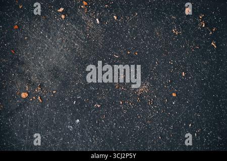 Old worn plastic cutting boards background with knife marks and scattered white bread crumbs, food preparation, bakery crumbs on board. Top view Stock Photo