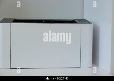 A sleek, contemporary printer sits in a minimalistic office space, providing a touch of elegance while supporting daily tasks. Stock Photo