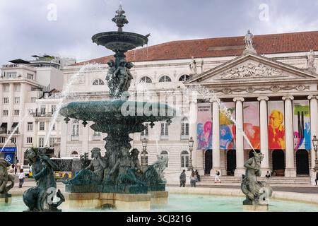 The north fountain in front of the National Theatre at Rossio Square in Lisbon, Portugal. The central square honors King Peter IV of Portugal. Stock Photo