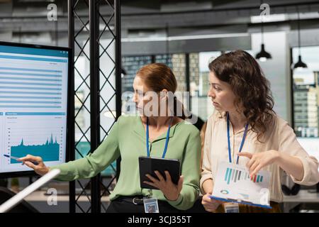 Powerful team of professional women meets in the boardroom to align goals and discuss insights of a multinational company, driving success through collaborative development and strategy. Stock Photo