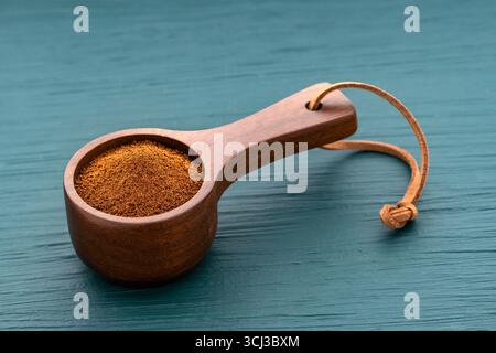 Dry instant ground coffee in a spoon - Coffea Stock Photo