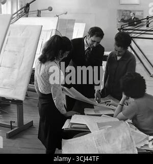 Engineers in a design bureau at a plant in Sloviansk collectively discussing blueprints, January 1978. The archival photograph shows the working atmosphere among the Soviet scientific and technical intelligentsia during the Era of Stagnation. This scene of intellectual, creative labor is a symbol of the peaceful scientific potential of Donbas before the wa Stock Photo