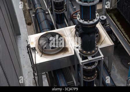 Industry HVAC system, Cooling tower, fan water Industry air conditioner system water valve pipe at roof top of building. Stock Photo