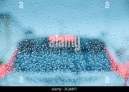 raining season on the road. driving in storm, heavy rain drop windshield, weather in rainy season Stock Photo