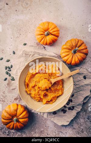 Organic orange pumpkin puree. Baked butternut squash, mashed pumpkin Stock Photo