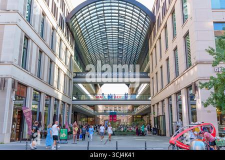 Berlin, Germany - August 16, 2025: Exterior view of the Mall of Berlin featuring its distinctive glass roof and bustling activity. Stock Photo