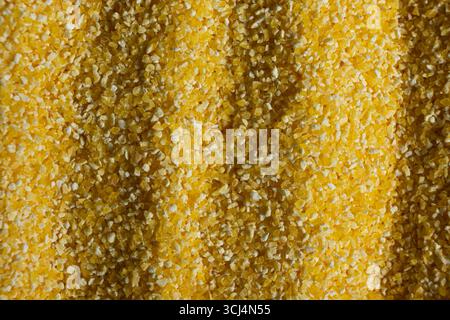 Abstract Yellow Cooking Corn Grits Background. Stock Photo