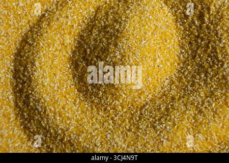 Abstract Yellow Cooking Corn Grits Background. Stock Photo