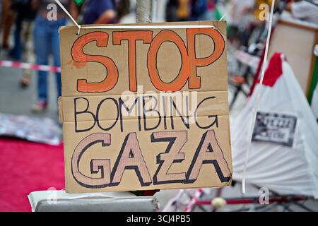 A sign saying Stop bombing Gaza at a Palestinian demonstration Turin against the war in Gaza Stock Photo