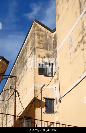 mouldy stone walls of a residential building in Italy Stock Photo