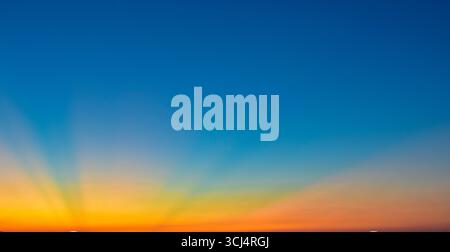 Beautiful gradient sky filled with magical, vivid colors during sunset or sunrise. Perfect nature background with dreamy, colorful atmosphere. Stock Photo
