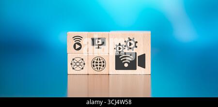 Wooden blocks with symbol of live streaming concept on blue background Stock Photo