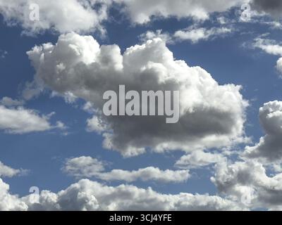 White clouds cumulus heap clouds in front of blue sky, international Stock Photo