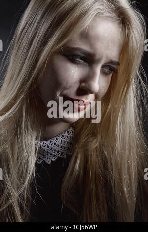 sad girl crying on black background Stock Photo - Alamy