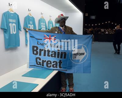 Birmingham NEC. Friday 5th September 2025. Reform party members arrive at the Reform Conference at the NEC, many wearing Union Jack outfits. PICTURED: Supporter Joseph Afrane highlights the 'Farage' T shirt on display. Bridget Catterall/AlamyLiveNews Stock Photo