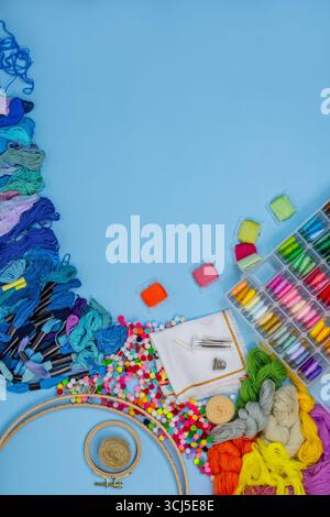 Embroidery threads and tools for handmade. Needlework accessories set for stitching. Embroidery accessories on the table. Stock Photo