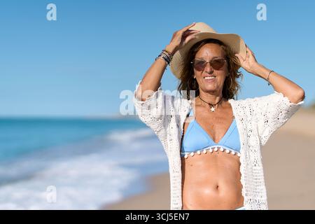 Senior woman enjoying summer vacation on the beach Stock Photo