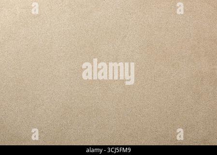 Detailed background of beige beach silicon sand texture, completely flattened, smooth and without ripples. Top view. Stock Photo