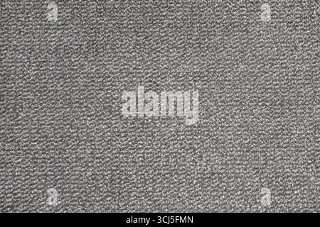 Textured background of gray carpet speckled with short-pile black and white cotton strands. Top view. Stock Photo