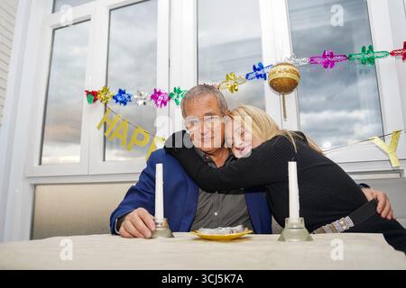 Senior couple hugging at new year party Stock Photo