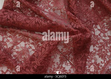 Red brocade fabric texture with white background. Stock Photo